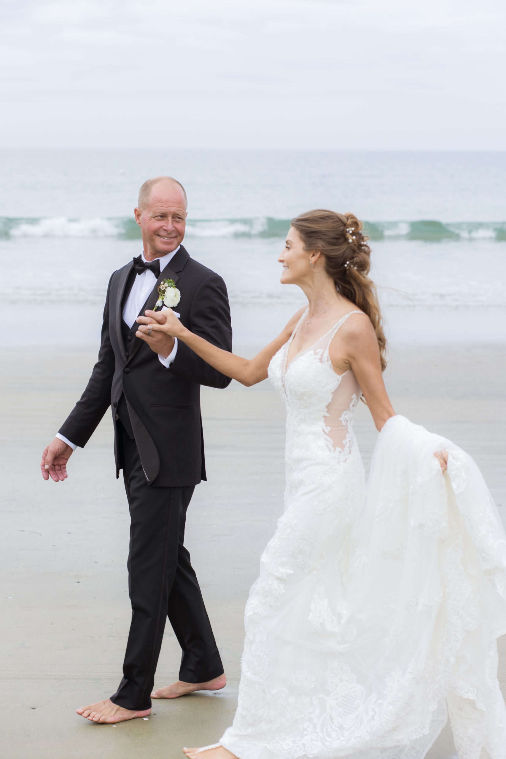 Bride and Groom walking along the beach at their Intimate La Jolla Shores Hotel Wedding
